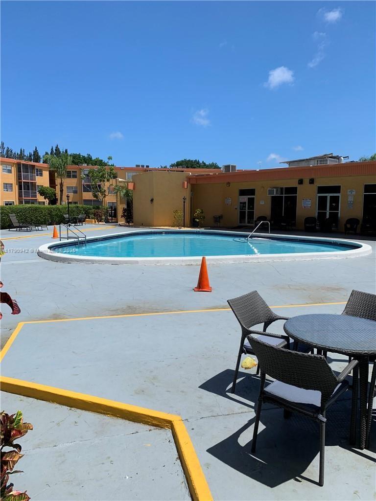 a view of a swimming pool with lounge chairs