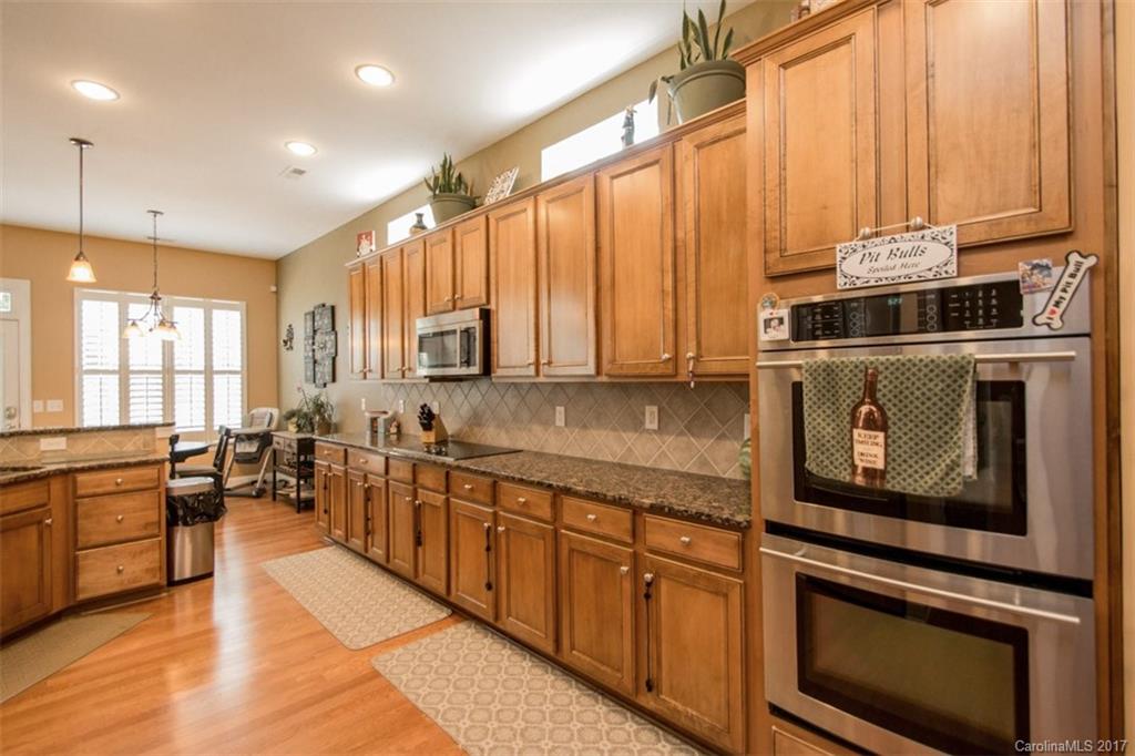 938 Treasure Court Fort Mill, SC 29708 - Photo 11 of 24 a kitchen with stainless steel appliances a stove sink and cabinets