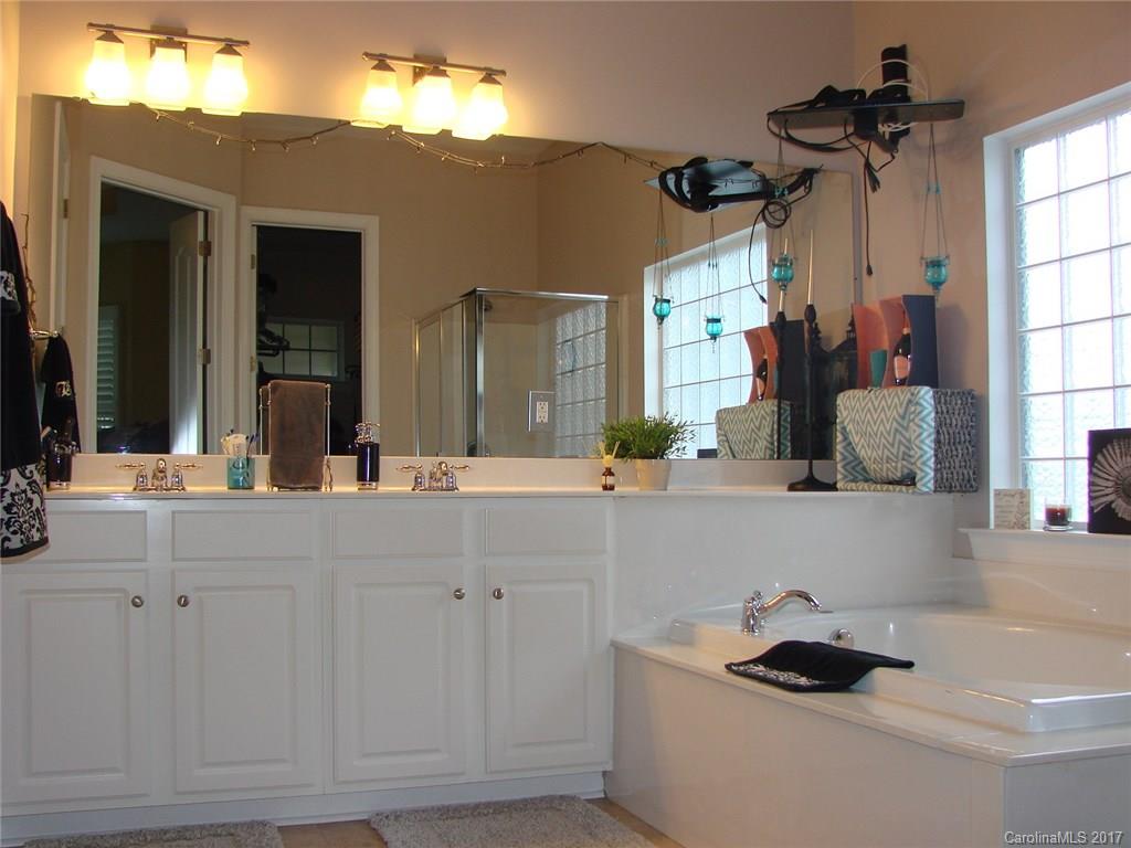 938 Treasure Court Fort Mill, SC 29708 - Photo 13 of 24 a bathroom with a sink and a mirror