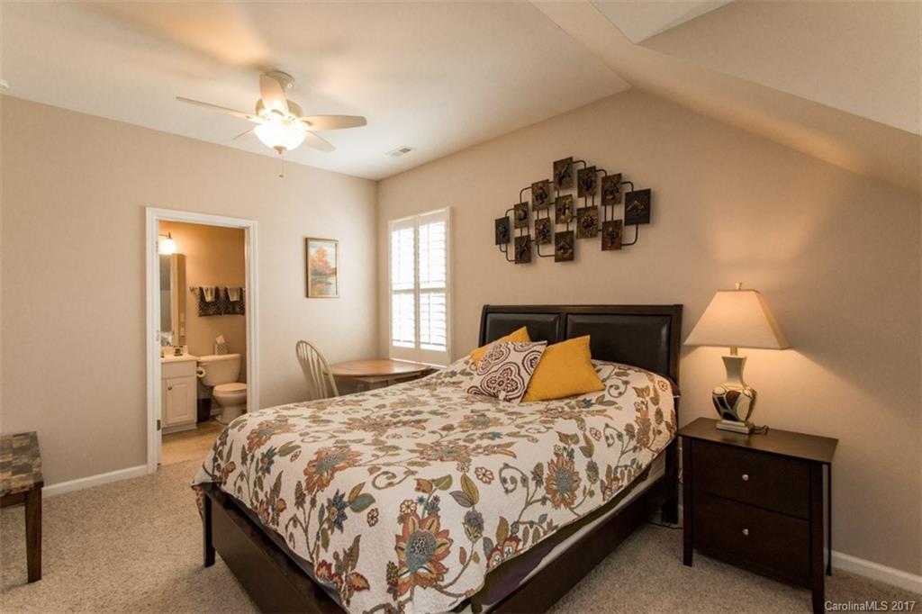 938 Treasure Court Fort Mill, SC 29708 - Photo 14 of 24 a bedroom with a bed and a chandelier