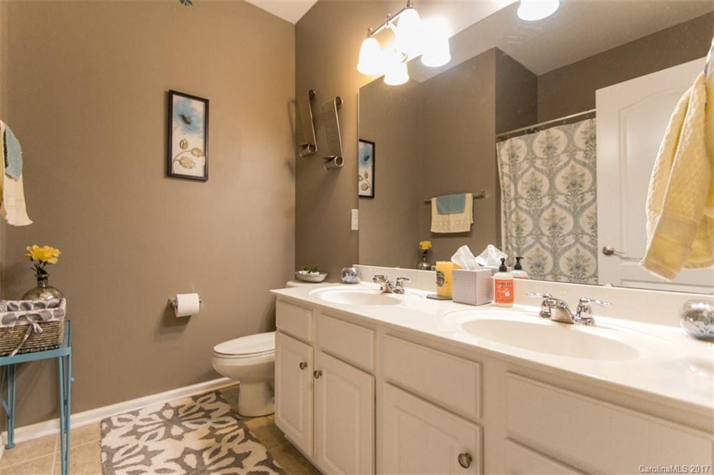 938 Treasure Court Fort Mill, SC 29708 - Photo 16 of 24 a bathroom with a double vanity sink toilet and a mirror