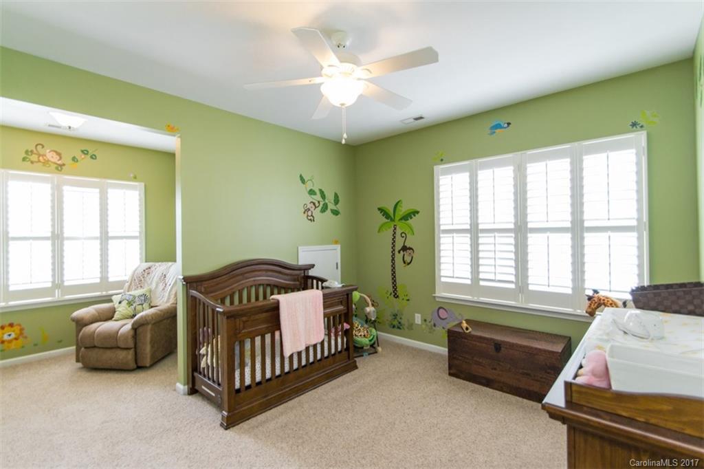 938 Treasure Court Fort Mill, SC 29708 - Photo 18 of 24 a spacious bedroom with a bed and a couch
