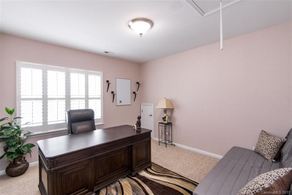 938 Treasure Court Fort Mill, SC 29708 - Photo 20 of 24 a bedroom with a bed and a desk