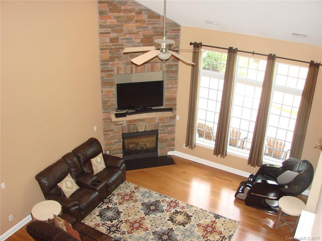 938 Treasure Court Fort Mill, SC 29708 - Photo 4 of 24 a living room with furniture a flat screen tv and a fireplace