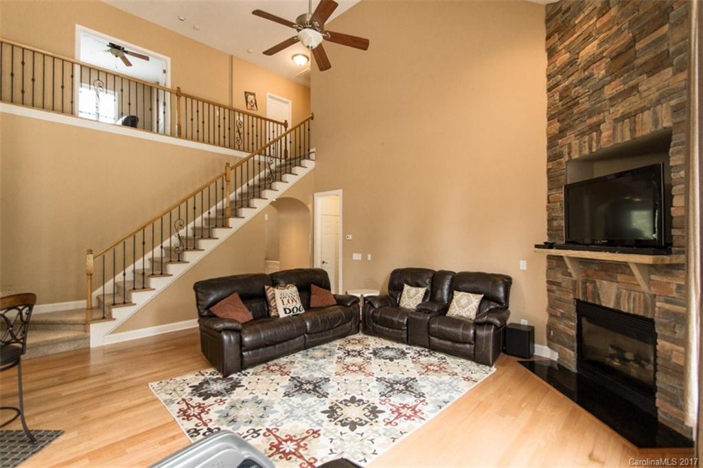 938 Treasure Court Fort Mill, SC 29708 - Photo 6 of 24 a living room with furniture fireplace and flat screen tv
