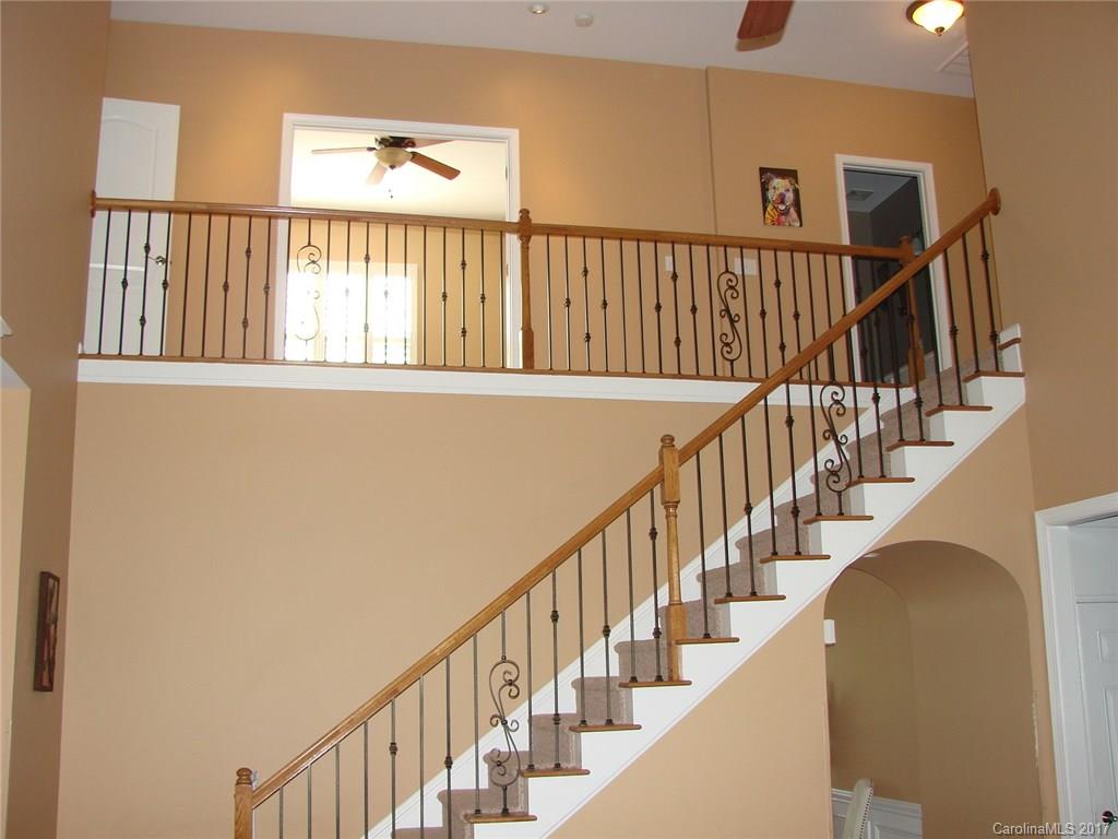 938 Treasure Court Fort Mill, SC 29708 - Photo 7 of 24 a view of staircase with wooden floor and a window