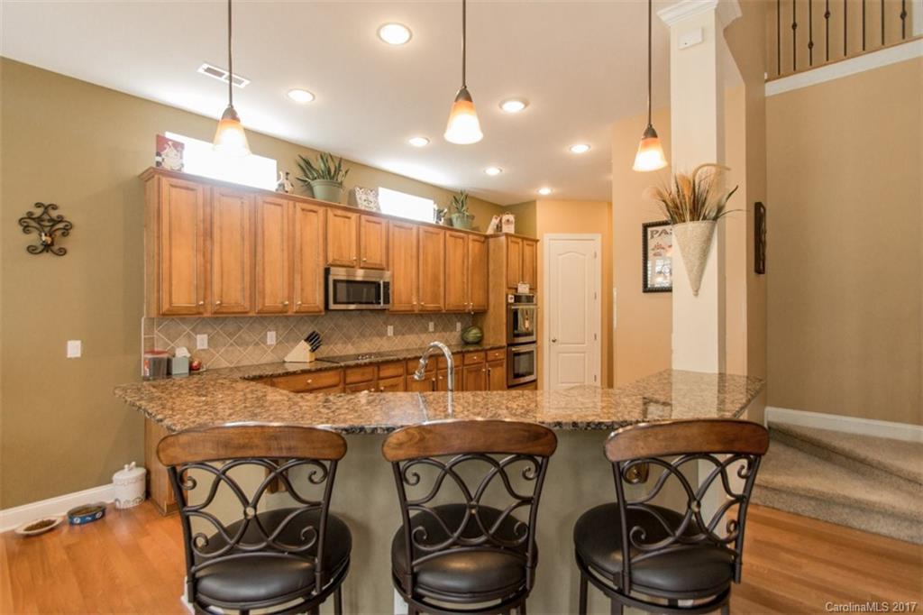 938 Treasure Court Fort Mill, SC 29708 - Photo 9 of 24 a kitchen with stainless steel appliances granite countertop a sink and a refrigerator