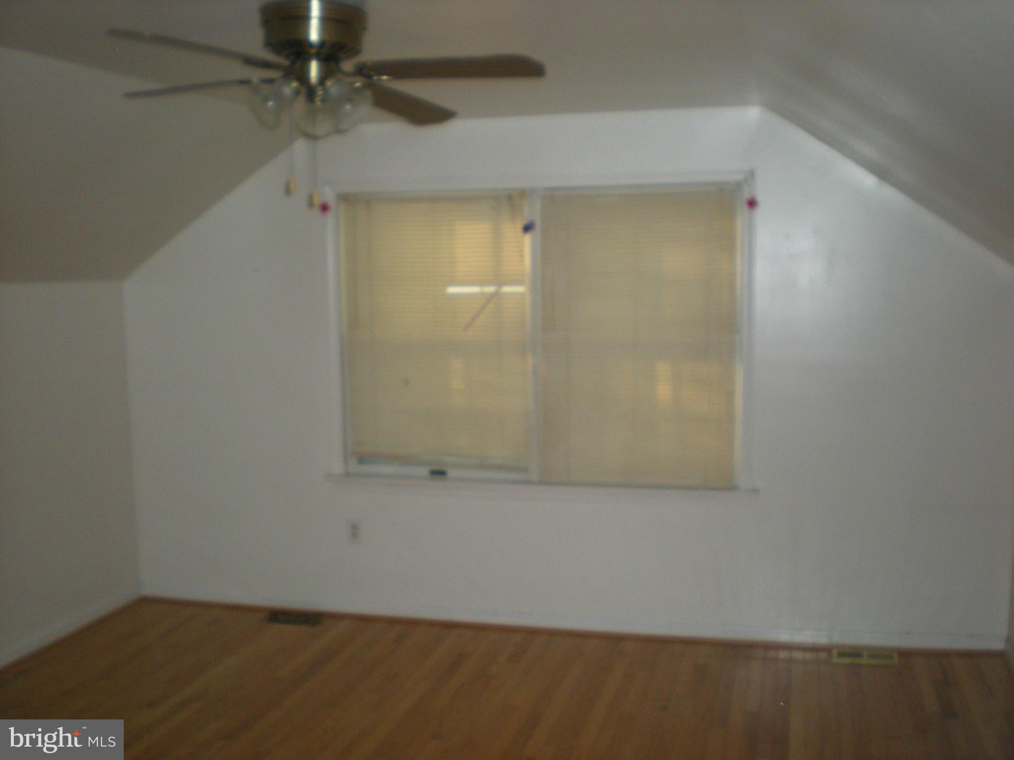 10812 Golf Course Terrace Bowie, MD 20721 - Photo 14 of 14 an empty room with a ceiling fan and carpet