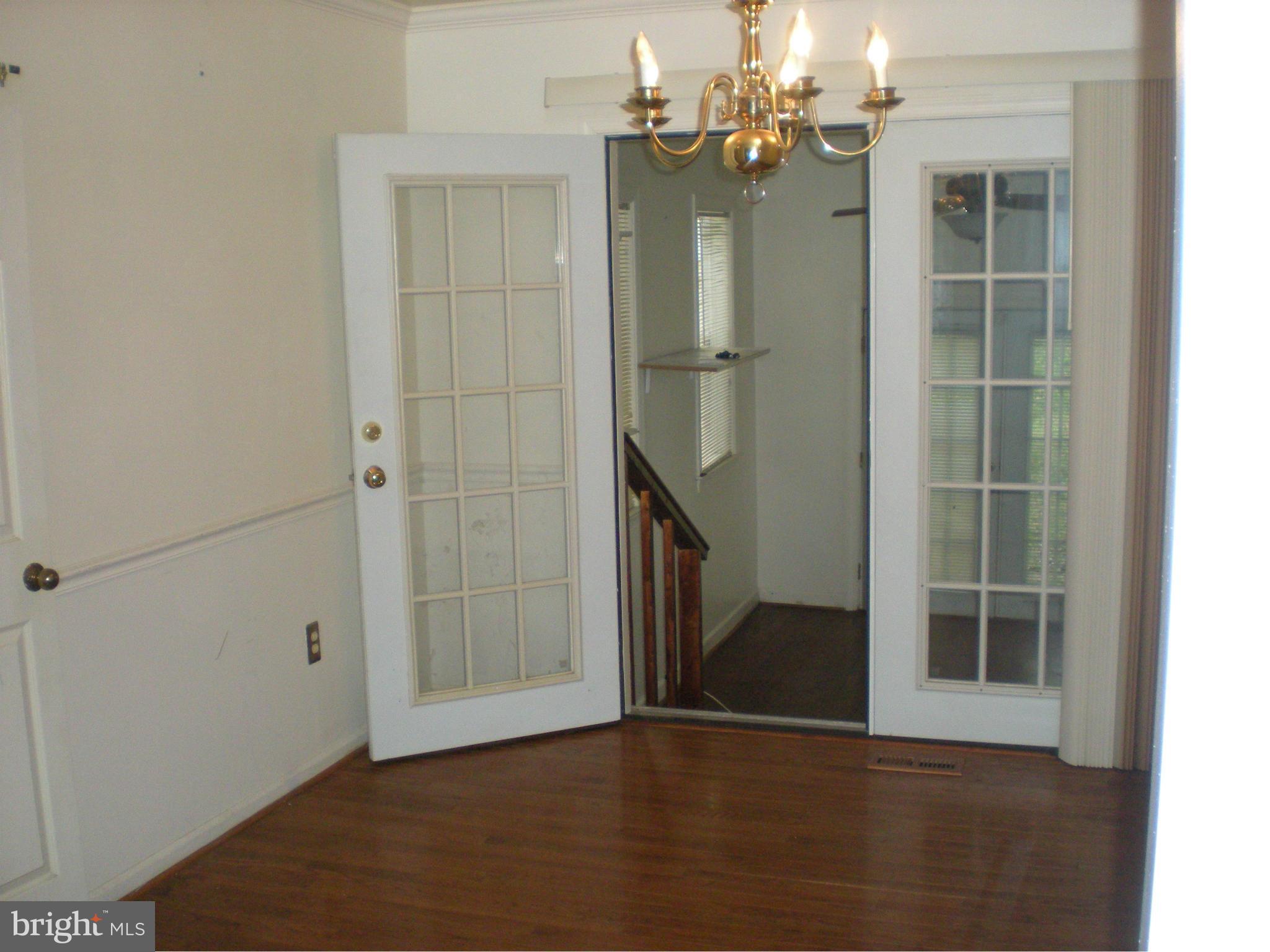 10812 Golf Course Terrace Bowie, MD 20721 - Photo 5 of 14 an empty room with wooden floor cabinet and windows