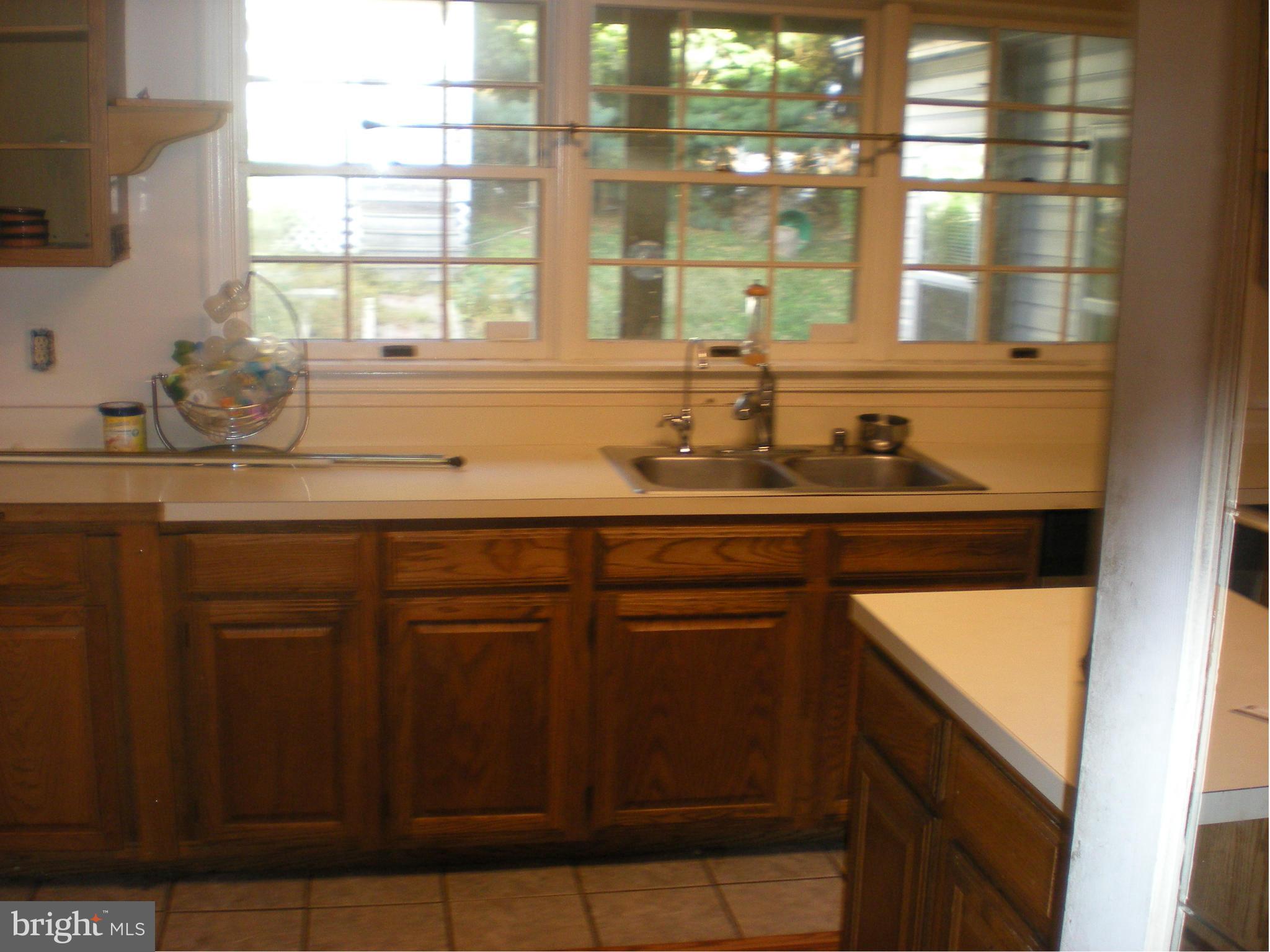 10812 Golf Course Terrace Bowie, MD 20721 - Photo 8 of 14 a kitchen with a sink and a window