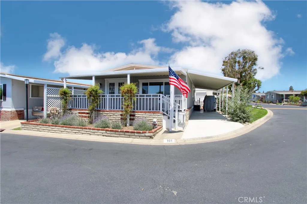 a view of a house with a big yard and large tree