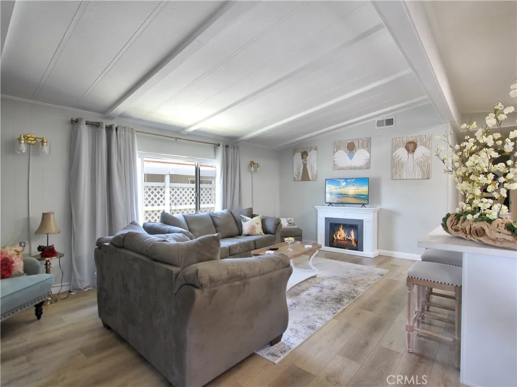 692 North Adele Street, Unit 101 Orange, CA 92867 - Photo 11 of 20 a living room with furniture a fireplace and a window