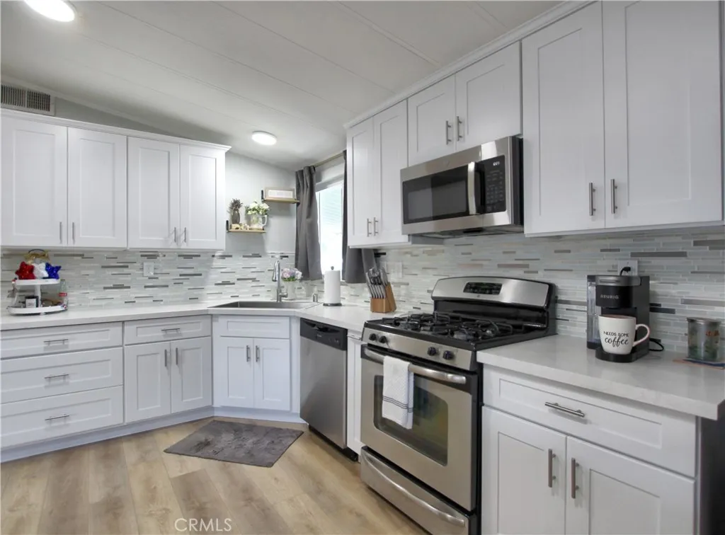 692 North Adele Street, Unit 101 Orange, CA 92867 - Photo 8 of 20 a kitchen with granite countertop cabinets stainless steel appliances and a counter space
