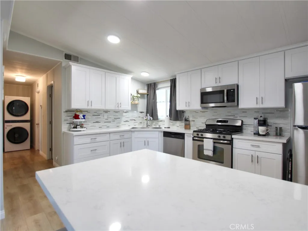692 North Adele Street, Unit 101 Orange, CA 92867 - Photo 10 of 20 a kitchen with granite countertop a sink stainless steel appliances and cabinets