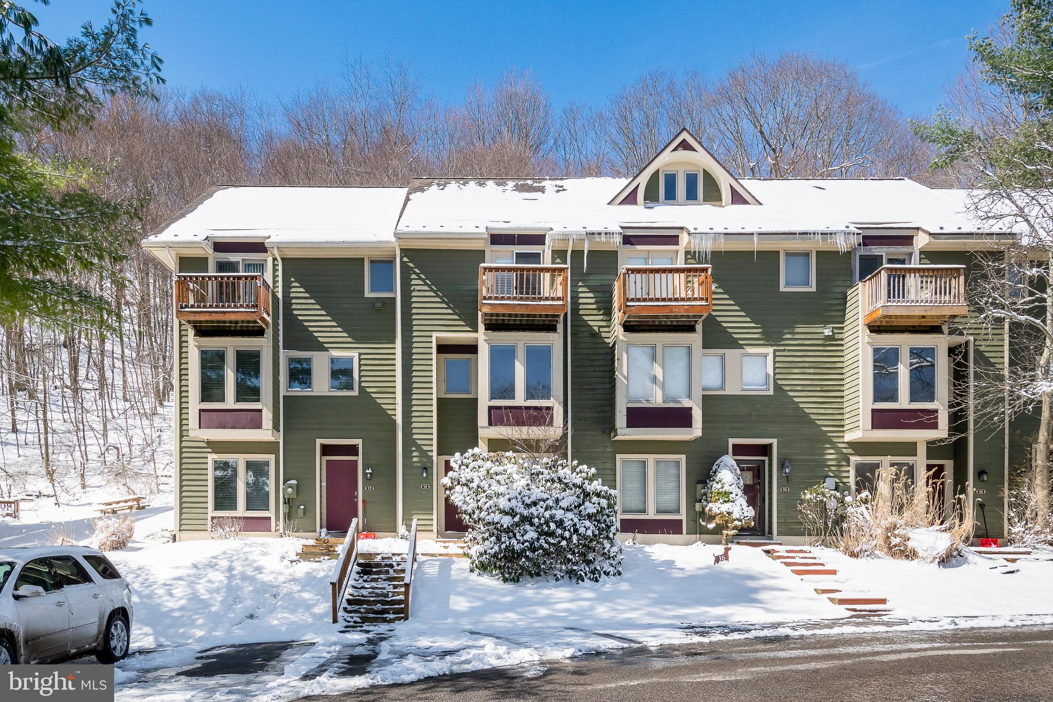 a front view of a residential apartment building with a yard