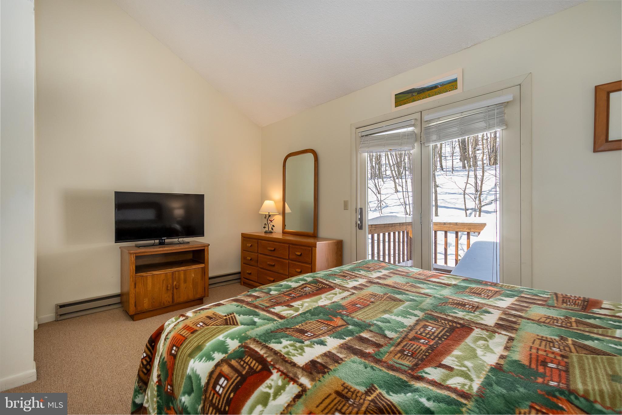 14 Winding Way, Unit 18B McHenry, MD 21541 - Photo 16 of 44 a bedroom with a bed and a flat screen tv