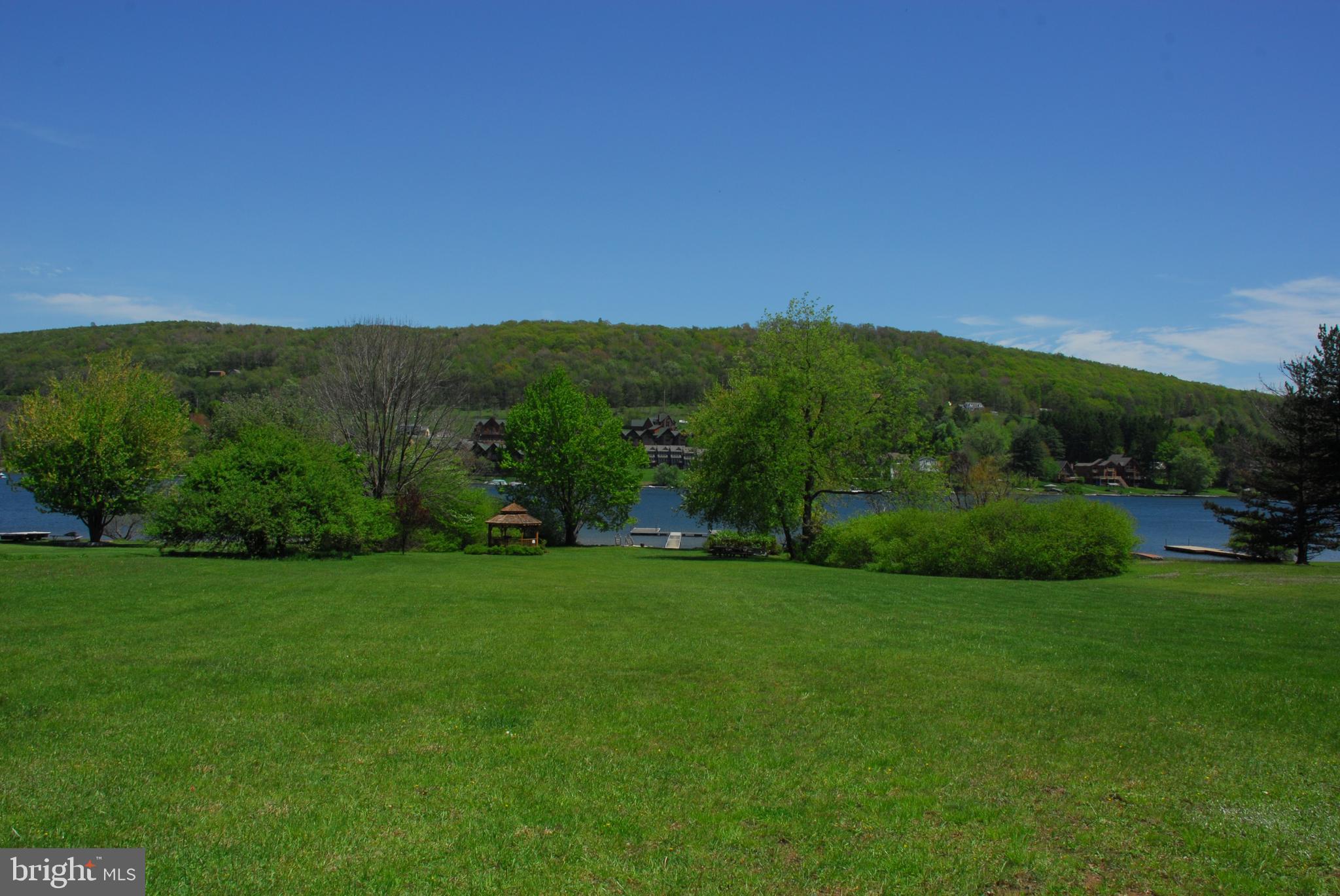14 Winding Way, Unit 18B McHenry, MD 21541 - Photo 32 of 44 a view of a grassy field with trees in the background