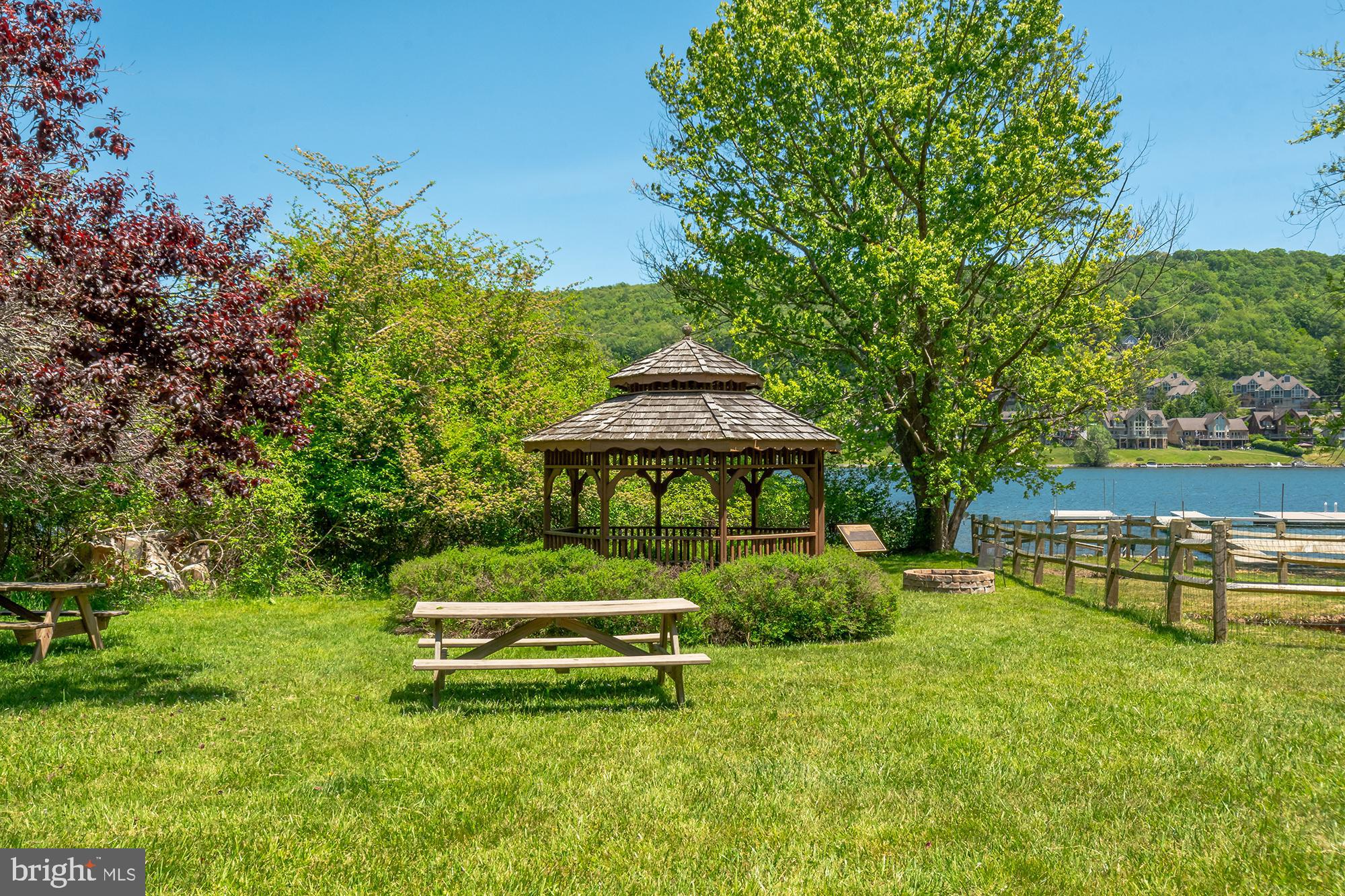 14 Winding Way, Unit 18B McHenry, MD 21541 - Photo 43 of 44 a garden with a bench and some trees