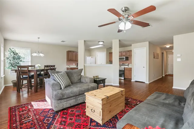 a living room with furniture and kitchen view