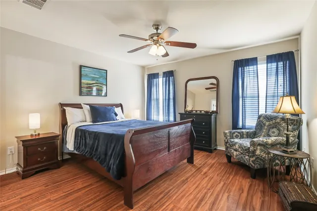 a bedroom with a bed and wooden floor