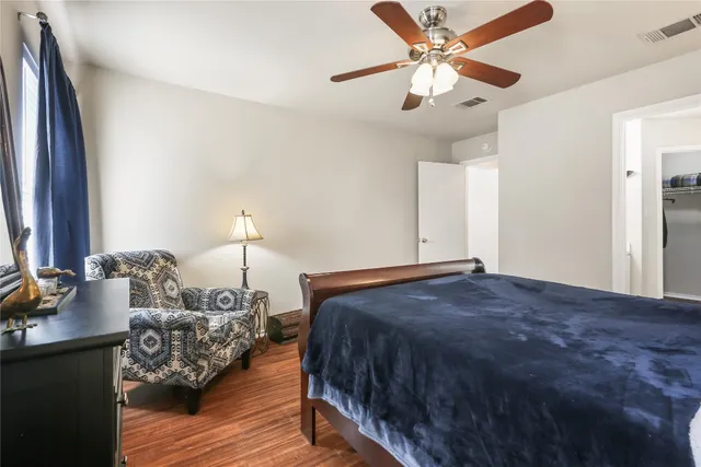 a bedroom with a bed and wooden floor
