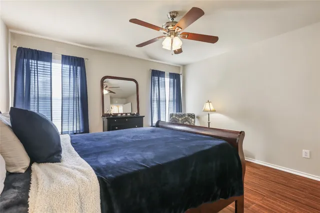 a bedroom with a bed mirror and window