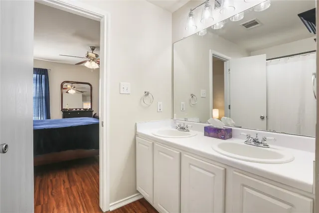 a en suite bathroom with a sink and a mirror
