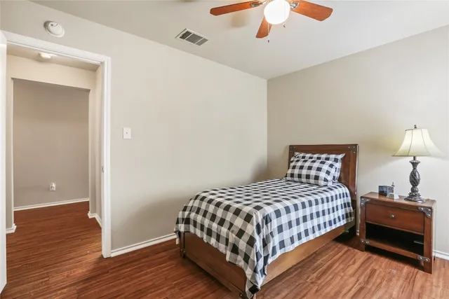 a bedroom with a bed and a lamp