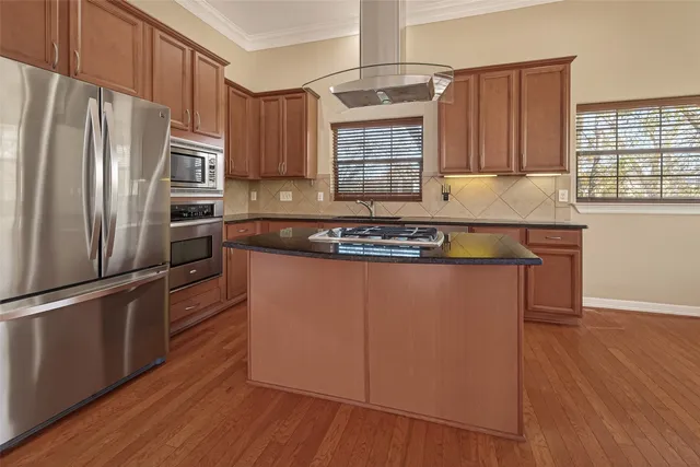 a bathroom with a granite countertop sink a toilet and a mirror