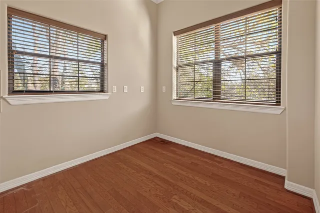 a kitchen with stainless steel appliances a refrigerator and wooden floor