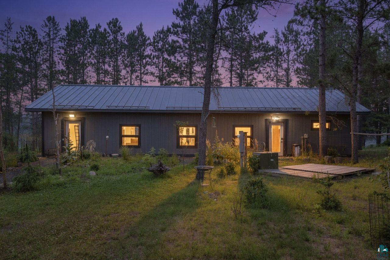 5400 Eightmile Lake Road Iron River, WI 54847 - Photo 1 of 37 Dark gray horizontal siding with a metal roof