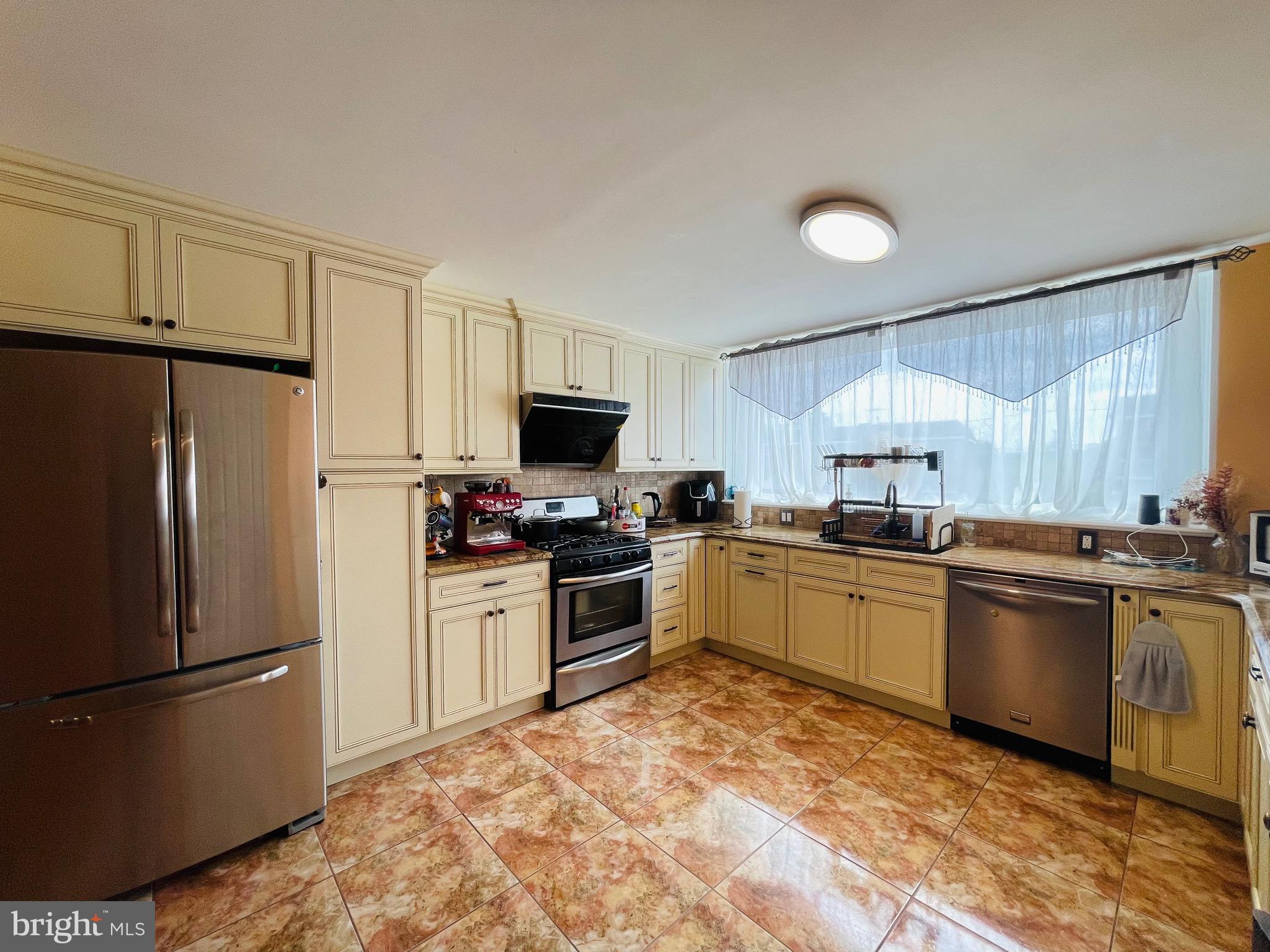 4247 Fairdale Road Philadelphia, PA 19154 - Photo 1 of 17 a kitchen with a refrigerator stove and microwave