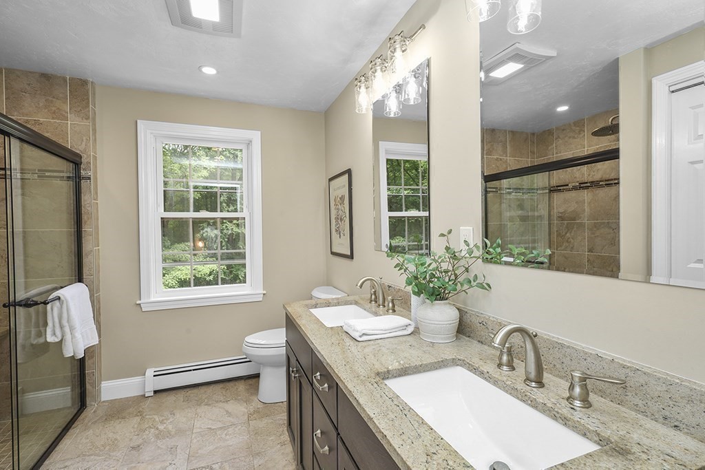 255 High Street Uxbridge, MA 01569 - Photo 22 of 34 a bathroom with a double vanity sink toilet and a mirror