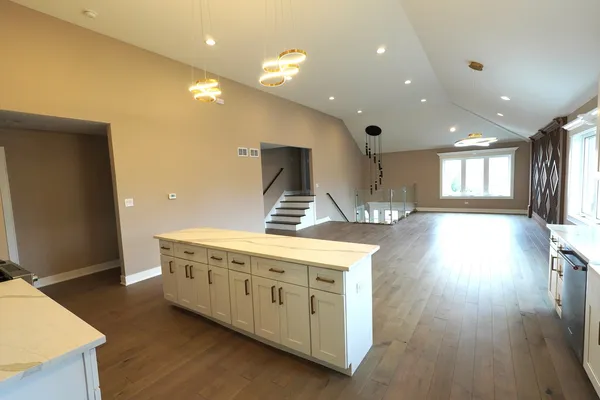 a kitchen with a wooden floor and window