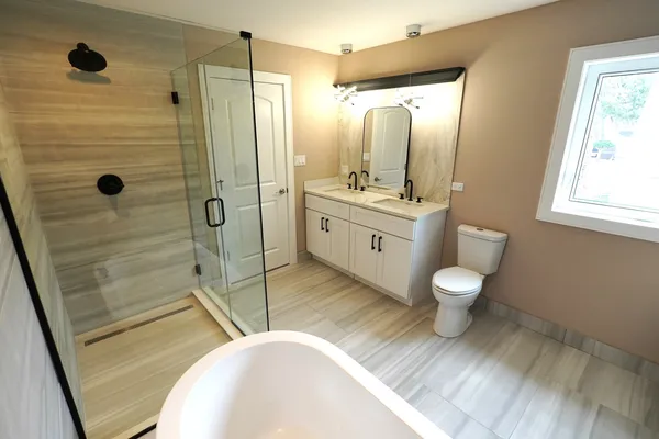 a bathroom with a granite countertop sink toilet and shower