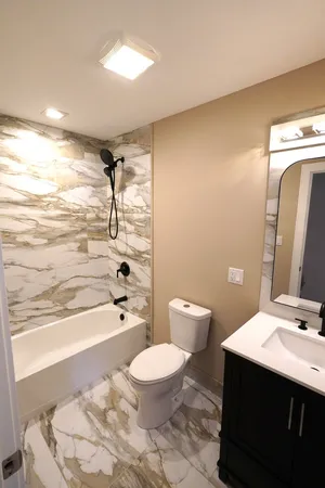 a bathroom with a sink a toilet and shower