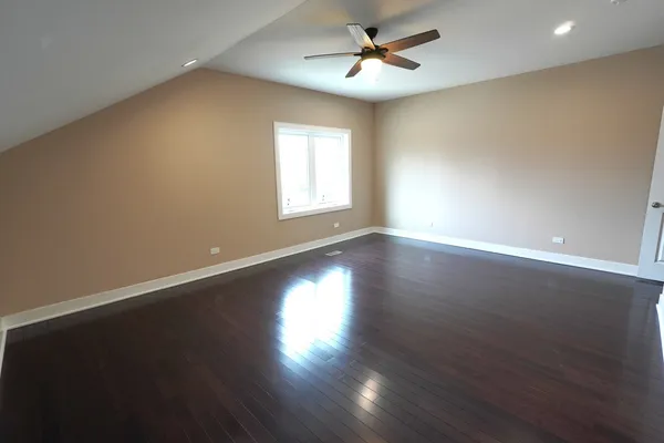 a view of wooden floor and windows in a room