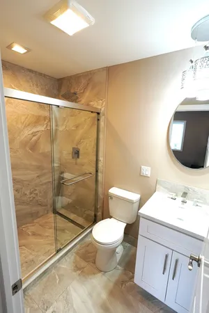 a bathroom with a sink toilet and shower