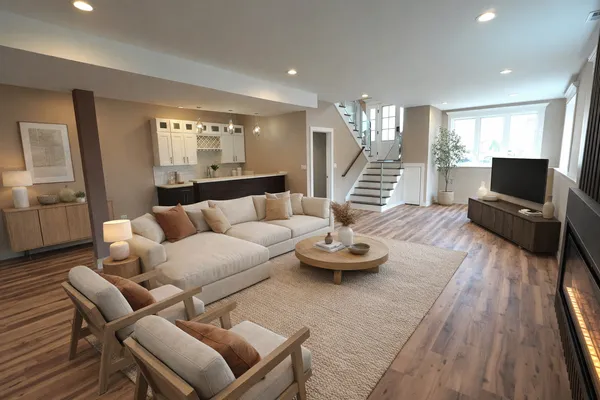 a living room with furniture and wooden floor