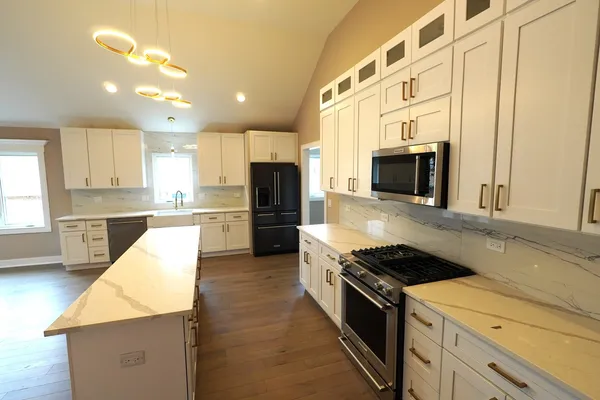 a kitchen with a stove a sink and a microwave