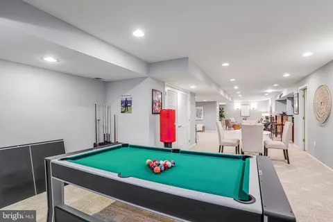 a living room with furniture a rug and gym equipment