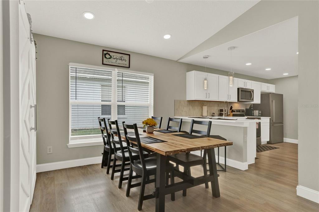 188 Ridgemont Court Davenport, FL 33896 - Photo 11 of 38 a view of a dining room with furniture and wooden floor