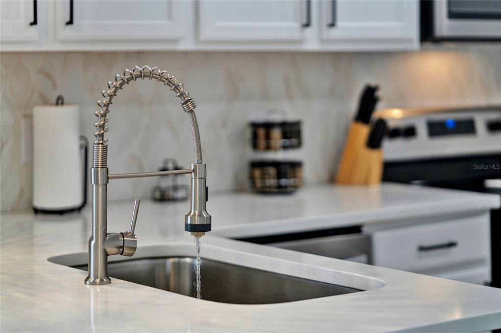 188 Ridgemont Court Davenport, FL 33896 - Photo 15 of 38 a kitchen with a sink and a mirror