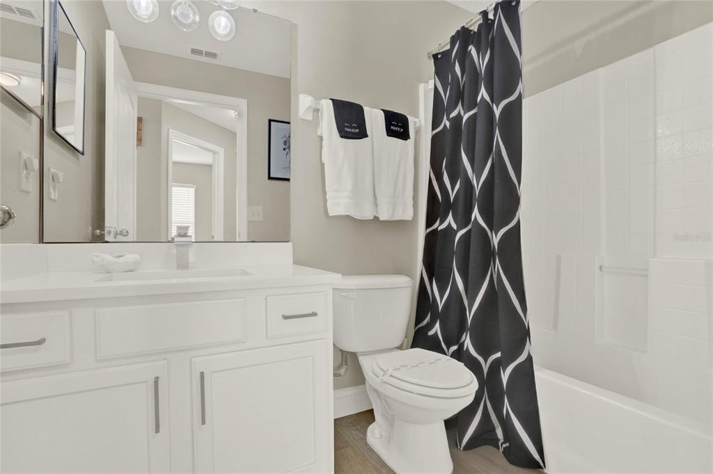 188 Ridgemont Court Davenport, FL 33896 - Photo 22 of 38 a bathroom with a granite countertop sink mirror vanity and toilet