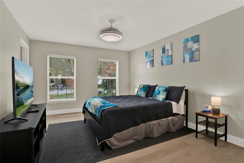 188 Ridgemont Court Davenport, FL 33896 - Photo 25 of 38 a bedroom with a bed and a flat tv screen on the dresser