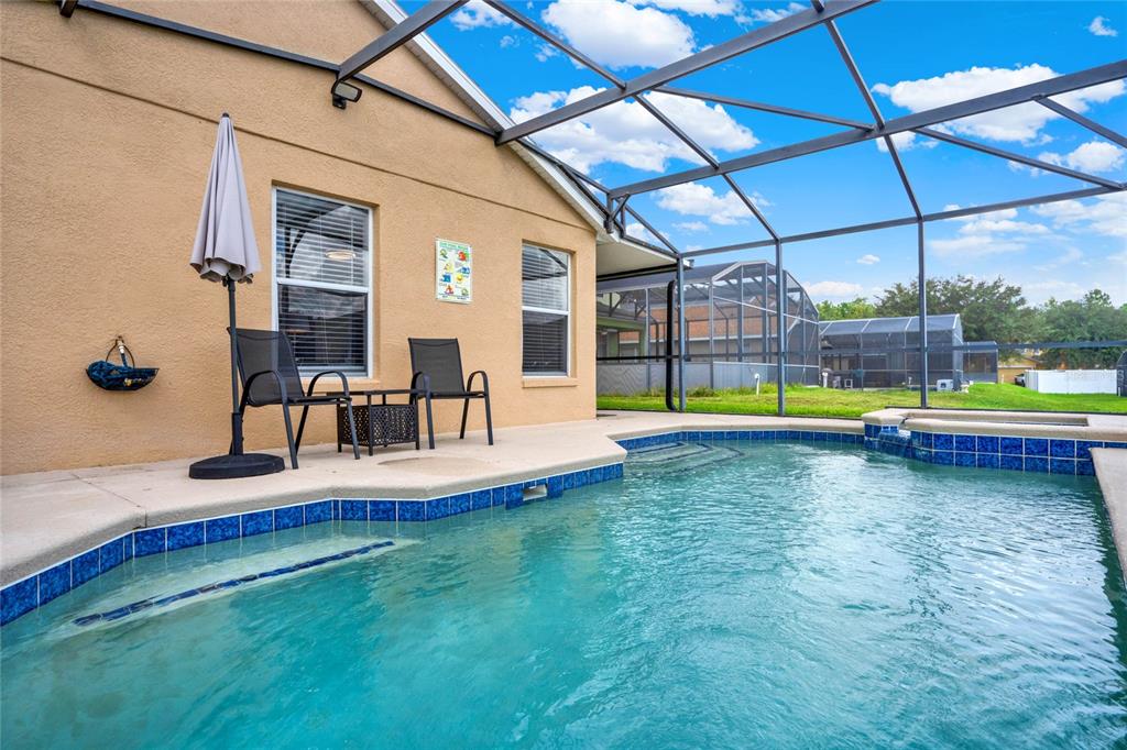 188 Ridgemont Court Davenport, FL 33896 - Photo 27 of 38 a view of a swimming pool with a porch