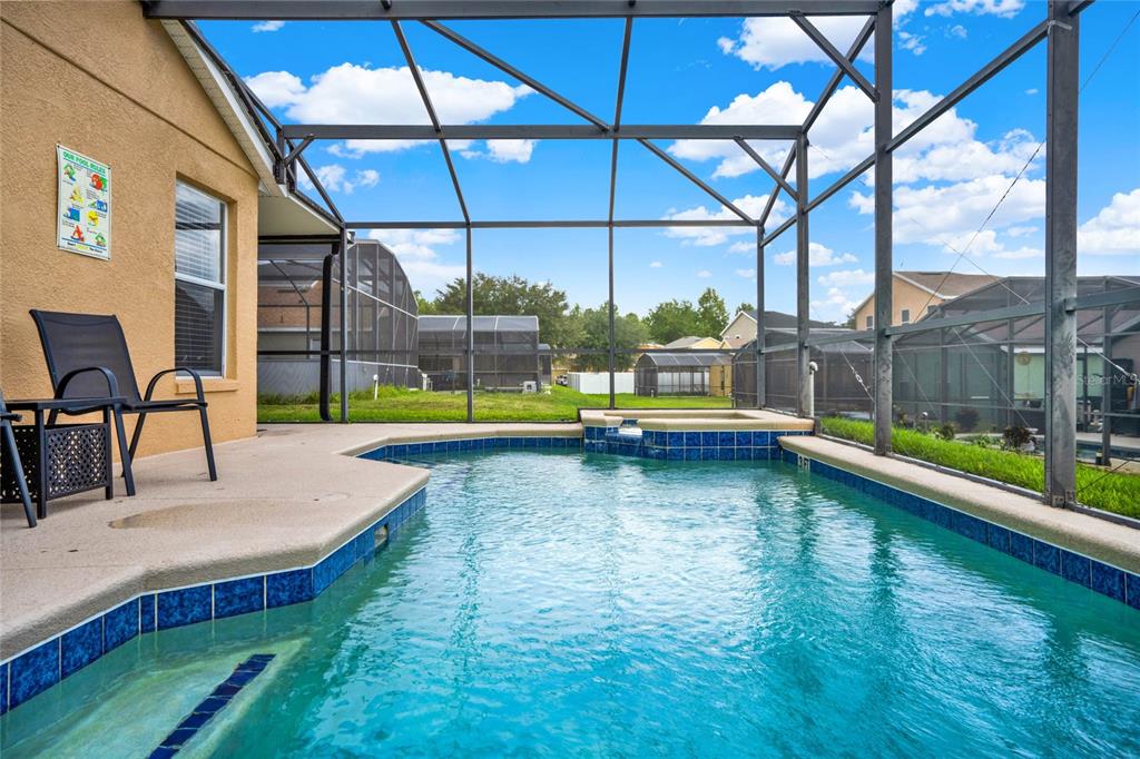 188 Ridgemont Court Davenport, FL 33896 - Photo 31 of 38 a view of a swimming pool with a lounge chairs