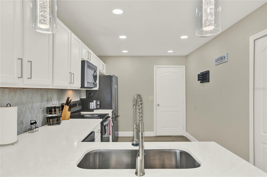 188 Ridgemont Court Davenport, FL 33896 - Photo 6 of 38 a kitchen with stainless steel appliances a refrigerator and a sink