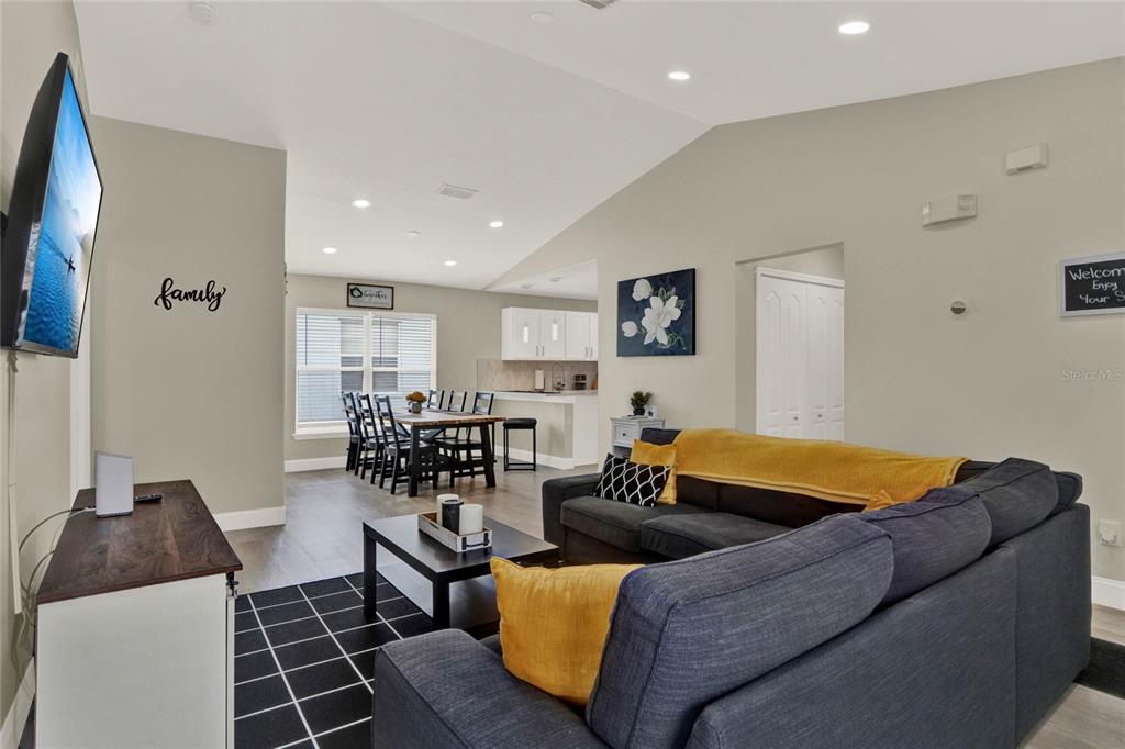 188 Ridgemont Court Davenport, FL 33896 - Photo 9 of 38 a living room with a couch and a flat screen tv