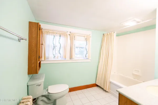 a bathroom with a toilet a sink and a shower